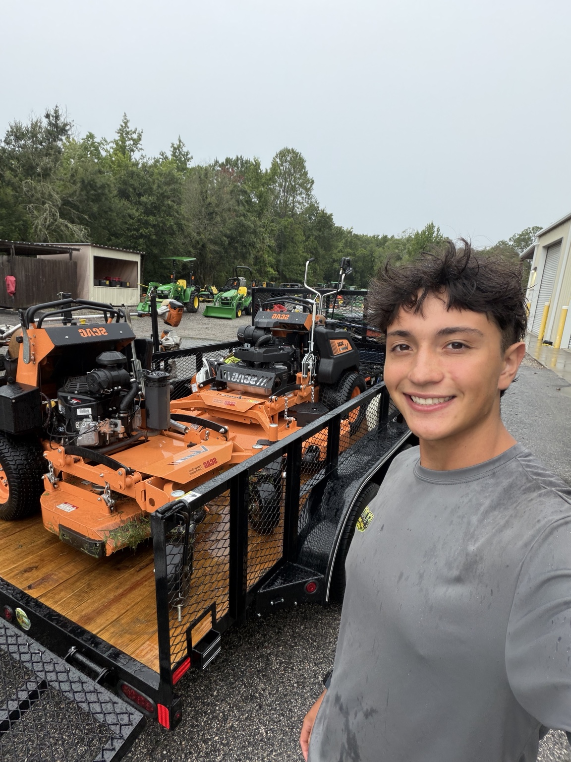 Sergio beside his trailer with two Scag mowers